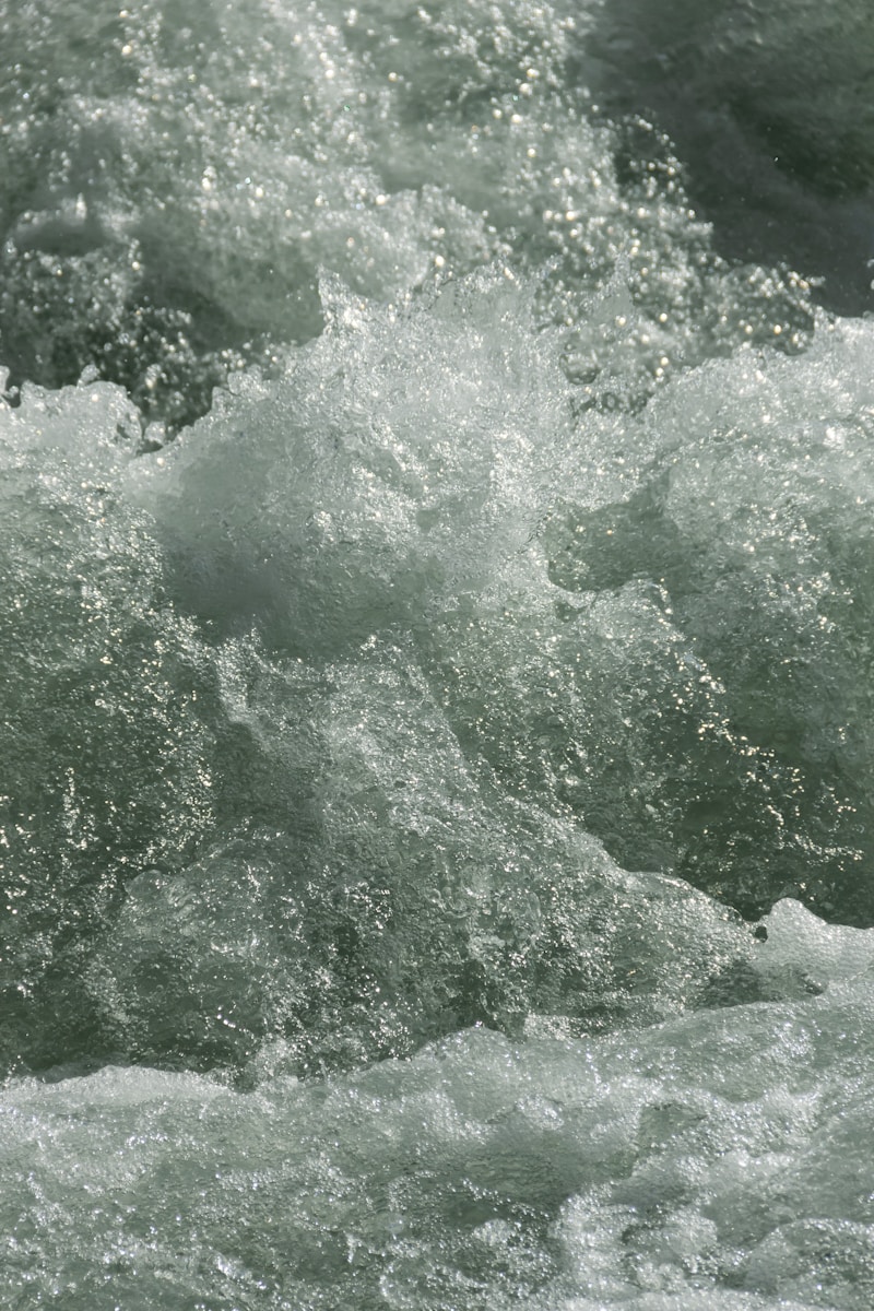 a man riding a surfboard on top of a wave